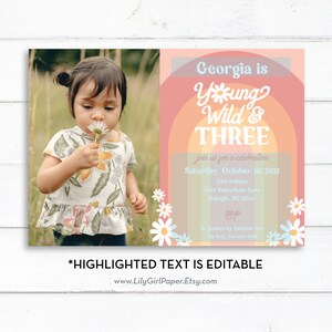 May include: A birthday invitation for a girl turning three. The invitation features a photo of a girl in a white dress with a daisy in her hand. The text on the invitation reads "Georgia is Young Wild & Three" with a rainbow background and daisy accents. The invitation includes the date, time, and location of the party.