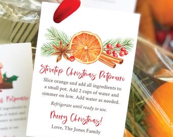 May include: A white gift tag with a watercolor illustration of orange slices, cinnamon sticks, star anise, and red berries. The text on the tag reads "Stovetop Christmas Potpourri" and includes instructions for making the potpourri. The tag also says "Merry Christmas!" and "Love, The Jones Family".