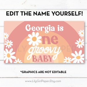 May include: A pink and orange banner with a rainbow design and daisies. The text on the banner reads "Georgia is one groovy baby".