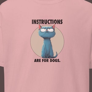 Grumpy cat, quirky feline, sarcastic humor, moody blue, cartoon design, funny artistic animal print, hand-drawn, unisex T-shirt, sassy vibe