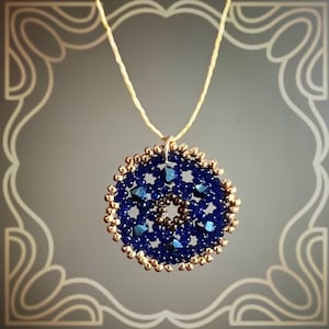 May include: A handcrafted pendant necklace featuring a circular design. The pendant is made of dark blue beads with a gold-colored beaded border. The necklace hangs from a thin, beige cord, creating an elegant and detailed accessory.