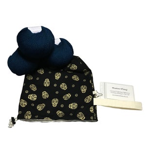 May include: Three skeins of dark blue yarn in a black drawstring bag with a gold sugar skull pattern. The bag has a white tag with the text "Heather Whimsy Handmade Yarn Bags & Accessories You'll Love to Live With www.heatherwhimsy.etsy.com"