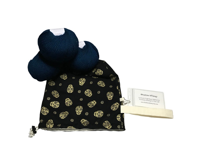 May include: Three skeins of dark blue yarn in a black drawstring bag with a gold sugar skull pattern. The bag has a white tag with the text "Heather Whimsy Handmade Yarn Bags & Accessories You'll Love to Live With www.heatherwhimsy.etsy.com"
