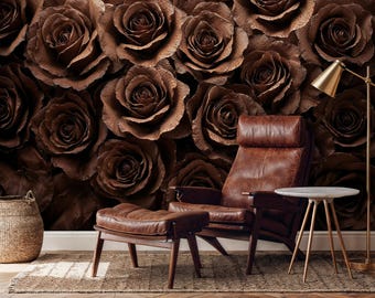 May include: A brown leather armchair and ottoman sit in front of a wall covered in large, textured brown roses. A small side table with a white top and gold legs is next to the chair. A gold floor lamp and a woven basket complete the scene.