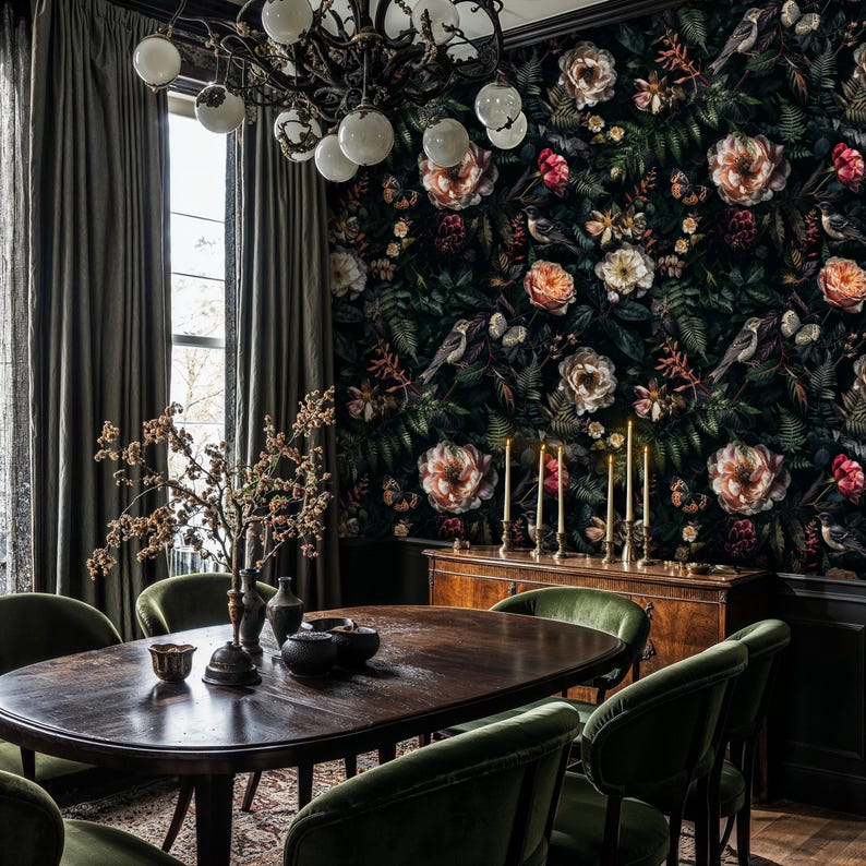 May include: A dark dining room with a floral wallpaper featuring pink and white roses, green leaves, and birds. The room has a dark wood table with six green velvet chairs, a chandelier, and a dark wood sideboard with candles.