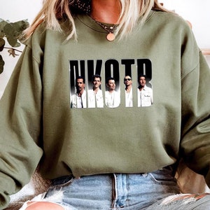 May include: A green sweatshirt with a graphic print of the band NKOTB. The band members are pictured in black and white, with the band's name in black letters.