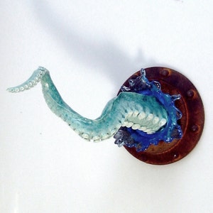 Octopus arm sculpture with porthole and splash image 4