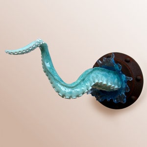 Octopus arm sculpture with porthole and splash image 1