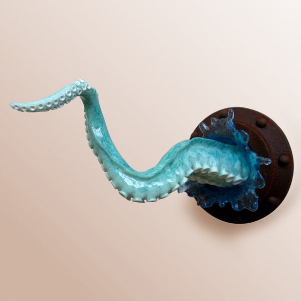 Octopus arm sculpture with porthole and splash