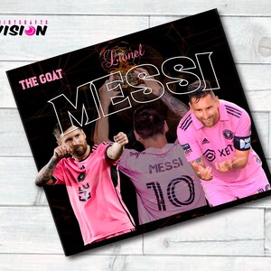 May include: A black and white graphic design with the text "The Goat" and "Lionel Messi" in a bold font. The image features a photo of Lionel Messi wearing a pink soccer jersey with the number 10 on the back. The jersey has black accents and the text "Messi" on the front.