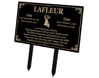 May include: Black metal memorial plaque with gold lettering and a deer silhouette. The plaque reads "LAFLEUR" and includes the names "Guy" and "Lise" with birth and death dates. The text reads "I love the great outdoors, Enjoying this great world of yours. Thank you for The fields and streams, because they're every Hunter's dream. Lord, I am blessed to be your child. Protect me when I'm in the wild. Today I ask and Humbly pray that I will have a fruitful day."