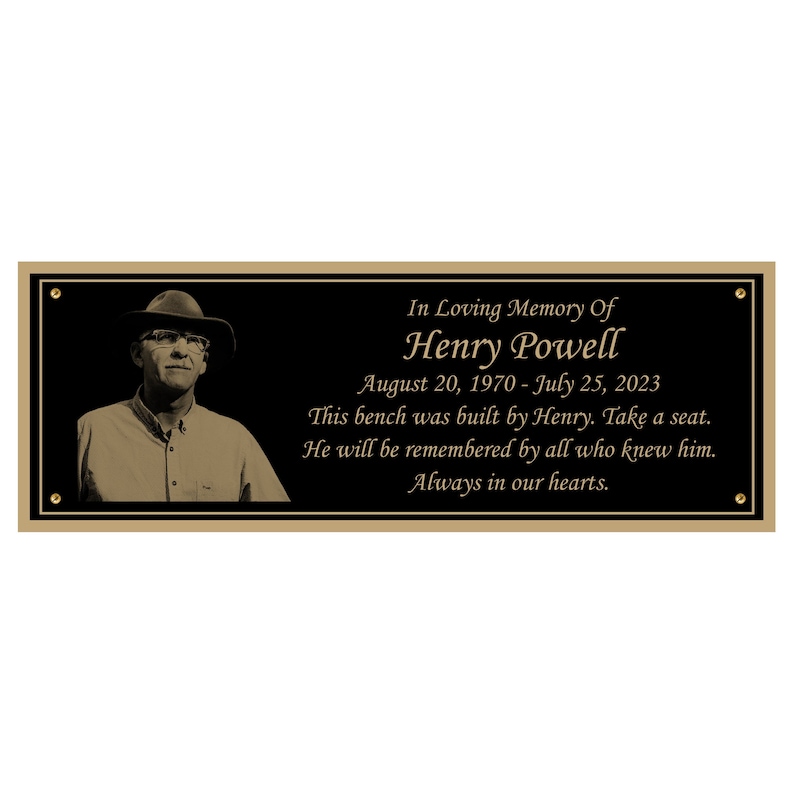 May include: A black memorial plaque with gold lettering. The plaque reads "In Loving Memory Of Henry Powell August 20, 1970 - July 25, 2023 This bench was built by Henry. Take a seat. He will be remembered by all who knew him. Always in our hearts."