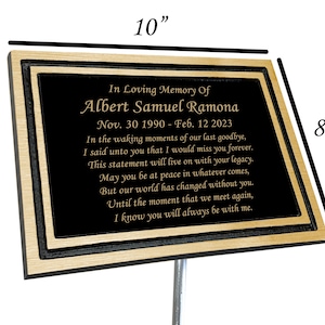May include: A black and gold memorial plaque with a personalized message for Albert Samuel Ramona. The plaque is 10 inches wide and 8 inches tall. It reads "In Loving Memory Of Albert Samuel Ramona Nov. 30 1990 - Feb. 12 2023 In the waking moments of our last goodbye, I said unto you that I would miss you forever. This statement will live on with your legacy. May you be at peace in whatever comes, But our world has changed without you. Until the moment that we meet again, I know you will always be with me."