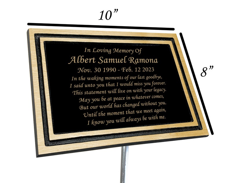 May include: A black and gold memorial plaque with a personalized message for Albert Samuel Ramona. The plaque is 10 inches wide and 8 inches tall. It reads "In Loving Memory Of Albert Samuel Ramona Nov. 30 1990 - Feb. 12 2023 In the waking moments of our last goodbye, I said unto you that I would miss you forever. This statement will live on with your legacy. May you be at peace in whatever comes, But our world has changed without you. Until the moment that we meet again, I know you will always be with me."