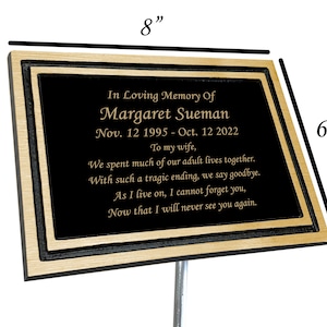 May include: A black and gold memorial plaque with a personalized message for Margaret Sueman. The plaque is 8 inches wide and 6 inches tall. It reads "In Loving Memory Of Margaret Sueman Nov. 12 1995 - Oct. 12 2022 To my wife, We spent much of our adult lives together. With such a tragic ending, we say goodbye. As I live on, I cannot forget you, Now that I will never see you again."