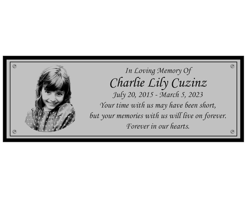 May include: A black and white photo of a young girl is on a silver plaque with the text "In Loving Memory Of Charlie Lily Cuzinz July 20, 2015 - March 5, 2023 Your time with us may have been short, but your memories with us will live on forever. Forever in our hearts."