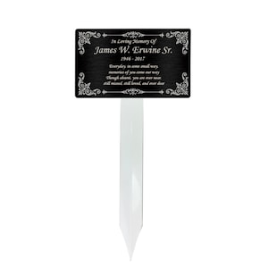 May include: Black metal memorial plaque with silver lettering. The plaque reads "In Loving Memory Of James W. Erwine Sr. 1946-2017 Everyday, in some small way, memories of you come our way. Though absent, you are ever near. Still missed, still loved, and ever dear."
