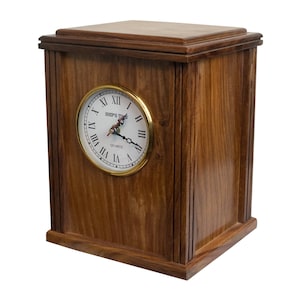May include: A wooden clock with a dark brown finish and a white face with black Roman numeral markings. The clock face has a gold trim and says "Steps Time" and "Quartz".