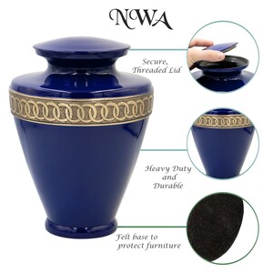 May include: A blue metal cremation urn with a gold trim and a threaded lid. The urn has a felt base to protect furniture.  NWA.