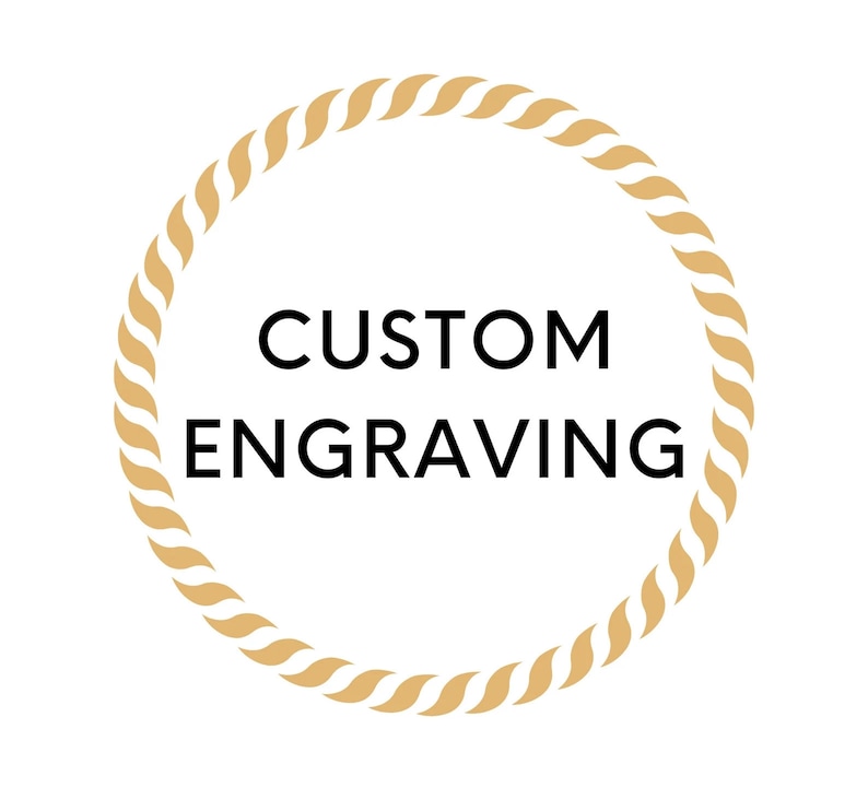 May include: A gold rope circle with the text "CUSTOM ENGRAVING" in black.