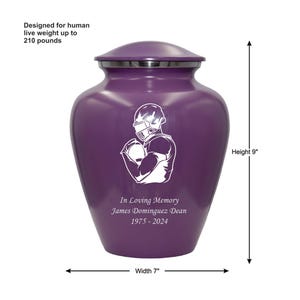 May include: Purple cremation urn with a white football player design. The urn is 9 inches tall and 7 inches wide. It has the inscription "In Loving Memory James Dominguez Dean 1975-2024".