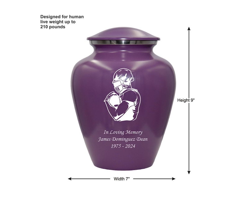 May include: Purple cremation urn with a white football player design. The urn is 9 inches tall and 7 inches wide. It has the inscription "In Loving Memory James Dominguez Dean 1975-2024".