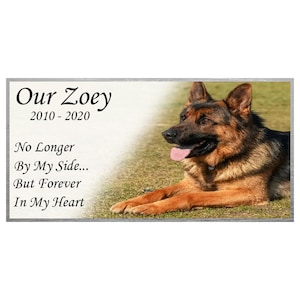May include: A memorial plaque with a photo of a German Shepherd dog. The plaque reads "Our Zoey 2010-2020 No Longer By My Side... But Forever In My Heart"