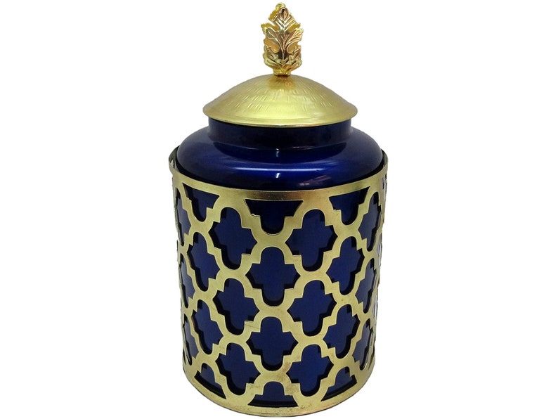 May include: A blue ceramic jar with a gold lid and a gold decorative cage. The lid has a gold leaf finial.