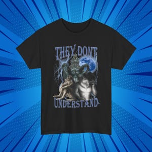 May include: Black t-shirt with a graphic of three wolves howling at the moon. The text "They Don't Understand" is printed below the wolves.