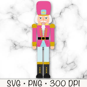 Op de afbeelding: Een roze en gouden notenkraker met een witte baard en snor. De notenkraker draagt een roze hoed met een gouden ster erop.