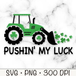 May include: Green tractor with a black bucket pushing a pile of green shamrocks. The text "Pushin' My Luck" is below the tractor.