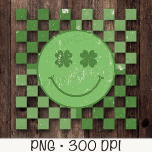 May include: A green smiley face with four-leaf clover eyes on a green and white checkered background. The background is a woodgrain texture.