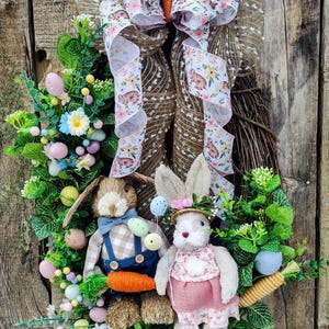 Adorable Easter wreath with a dapper rabbit couple, Easter eggs, carrots, eucalyptus and daisies. .