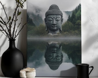 May include: A canvas print depicting a Buddha head statue reflected in still water. The artwork shows a backdrop of misty mountains and green trees, creating a peaceful scene. A black vase and other decorative items are in the foreground, adding to the composition.