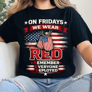 May include: Black t-shirt with the text "ON FRIDAYS WE WEAR RED REMEMBER EVERYONE DEPLOYED" in white and red. The design includes an American flag and dog tags.