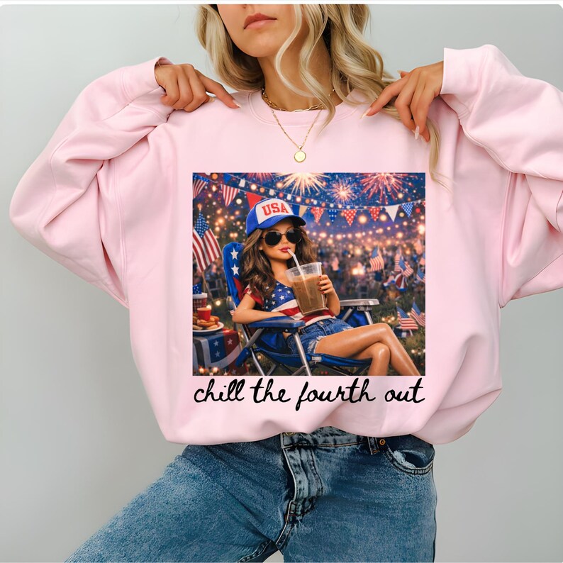 May include: A light pink sweatshirt featuring a graphic of a woman in sunglasses, a USA hat, and denim shorts, enjoying a drink. The graphic includes fireworks and American flags. The text "chill the fourth out" is below the graphic.