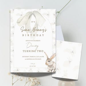 May include: A white invitation with a watercolor illustration of a bunny rabbit and a bow. The text reads "It's Some Bunny's Birthday. Join us to celebrate Daisy Turning Two. Saturday, March 15 at 3:00 PM. 111 Hopper Ln City State. RSVP 111-111-1111."