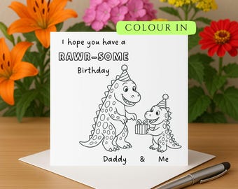 May include: A white greeting card with a black and white dinosaur illustration. The card reads "I hope you have a RAWR-SOME Birthday" with the words "Daddy & Me" below the illustration. A silver pen rests on the envelope.