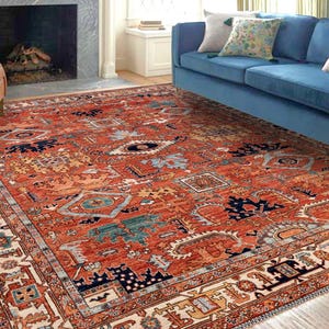 May include: A red, blue, and cream patterned rug with a detailed geometric design. The rug has a cream border with intricate patterns.