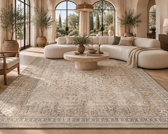 May include: A large rectangular area rug featuring a detailed, faded-look pattern in shades of beige, cream, soft grey, and muted gold. The design includes a central medallion surrounded by intricate floral and geometric borders.