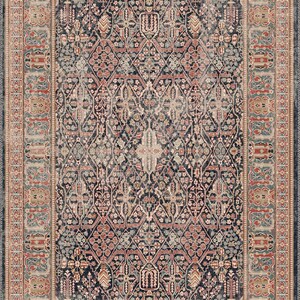 May include: A rectangular area rug with an intricate, traditional design. The rug features a dark navy blue central field with a repeating floral and geometric pattern in shades of red, beige, and teal. A detailed border frames the design.