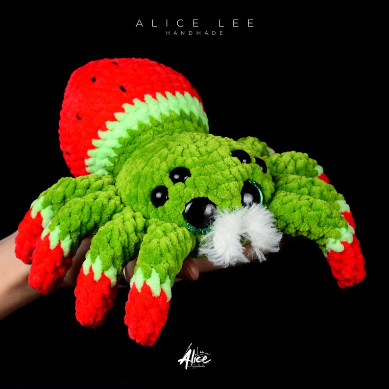 Watermelon Jumping Spider Plush. Green and red crochet toy with large black eyes and white fuzzy chelicerae (beard). Fruit-themed spider gift. Alice Lee Handmade.