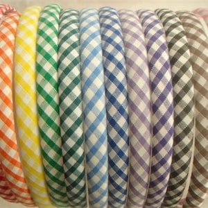 May include: A set of ten gingham fabric headbands in various colors, including red, yellow, green, blue, purple, gray, and pink.