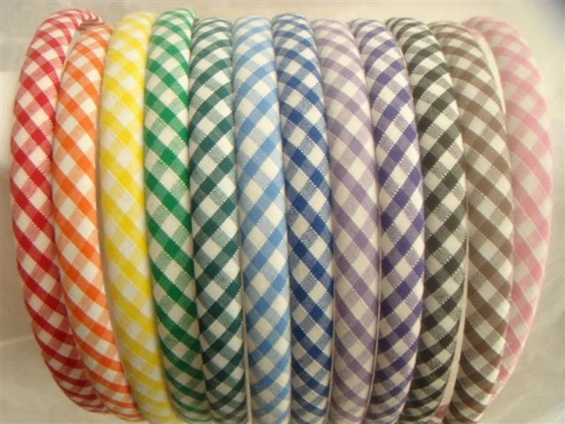 May include: A set of ten gingham fabric headbands in various colors, including red, yellow, green, blue, purple, gray, and pink.