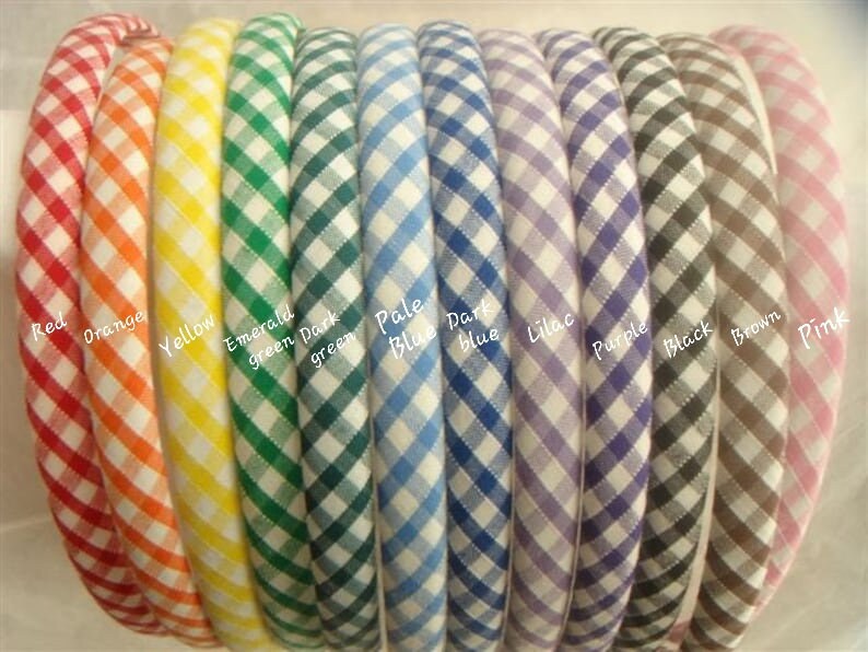 May include: A set of 12 gingham hair bands in various colors, including red, orange, yellow, emerald green, dark green, pale blue, dark blue, lilac, purple, black, brown, and pink.