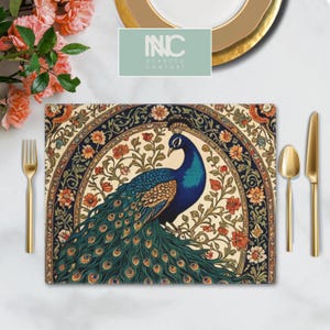 May include: A peacock with a blue and green tail feathers is featured on a placemat with a circular floral pattern. The placemat has a cream background with blue, red, and green accents. The text "INC NUANCED COMFORT" is visible in the top center of the image.