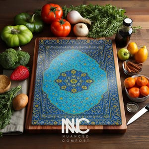 May include: A wooden cutting board with a decorative glass top featuring a blue and gold floral design. The board is surrounded by fresh produce, including tomatoes, garlic, and oranges. The text "INC NUANCED COMFORT" is visible.