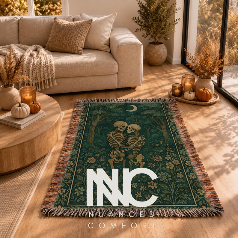 May include: A rectangular woven throw blanket featuring a dark green background with a central illustration of two skeletons embracing in a forest. The design includes a crescent moon, trees, and floral patterns with a fringed edge and the text NNC NUANCED COMFORT.