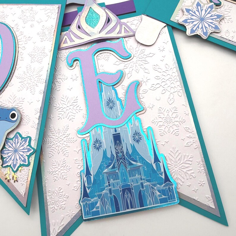 May include: A white ceramic mug with a black handle and the text "But First, Coffee" in a black, handwritten-style font. The mug is on a white surface.