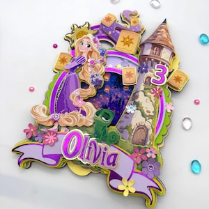 May include: A layered, colorful birthday cake topper featuring a princess in a purple dress with long blonde hair. The design includes a tower, the number 3, the name "Olivia", and floating lanterns. The background shows a castle and a green chameleon.